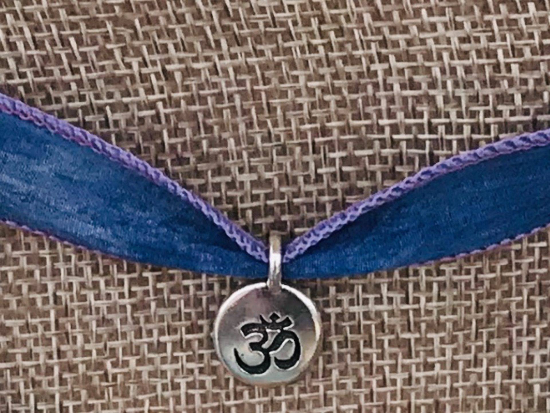 #67 NECKLACE ($30): Silver Om Symbol Charm, Purple Silk Ribbon
